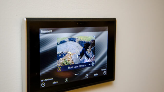 Home security system flat screen live feed monitoring the front door through a camera JL Entertainment installation
